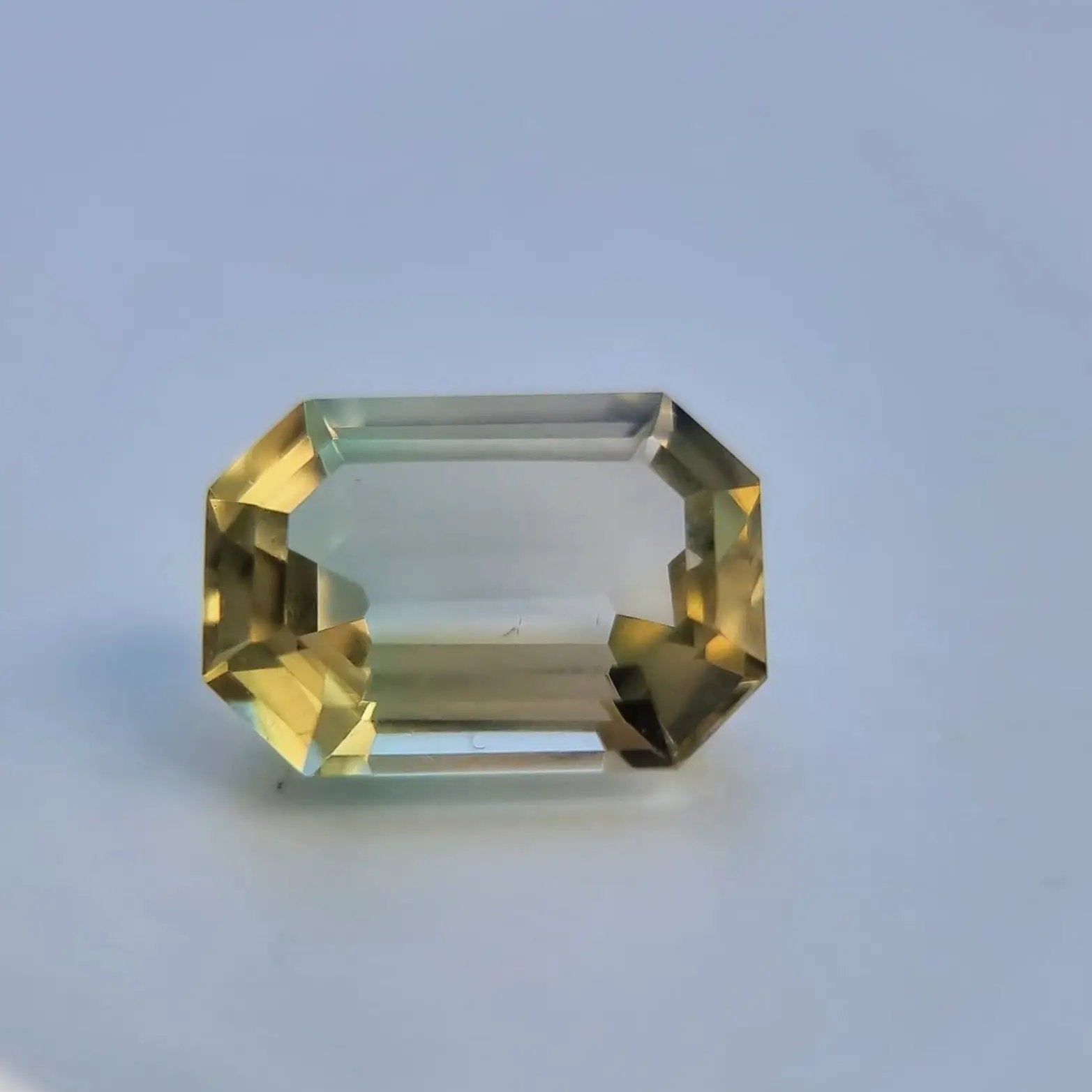 Loose 6.1ct emerald cut bi-color tourmaline with exceptional clarity and untreated natural tones, ideal for fine jewelry.