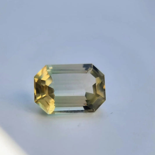 6.1ct emerald cut tourmaline gemstone with bi-color yellow and green hues, ideal for collectors or custom jewelry settings.