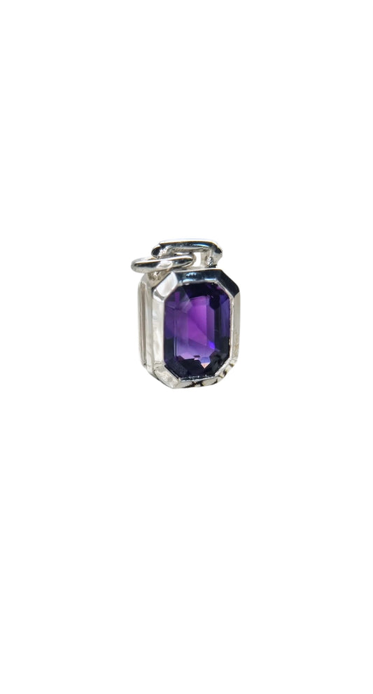 Side view of emerald cut amethyst sailor pendant in silver, highlighting the gemstone's clarity and modern bezel setting.