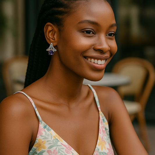 Model wearing handcrafted amethyst silver earrings with resin inlay, showcasing geometric hut-inspired design and vibrant purple gemstones for a bold look.