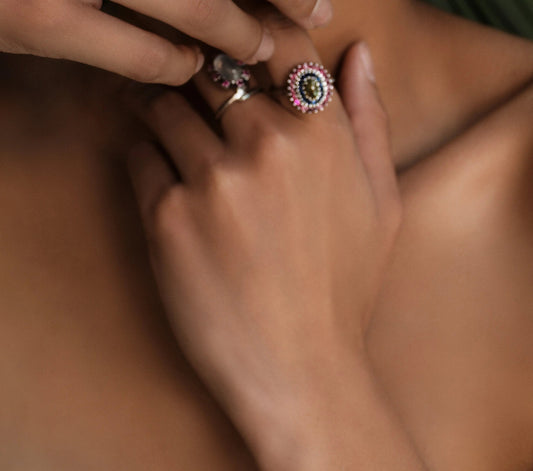 Model wearing a Natural Cat's Eye Chrysoberyl and Sapphire Cocktail Ring, showcasing its intricate gemstone arrangement and luxurious design.
