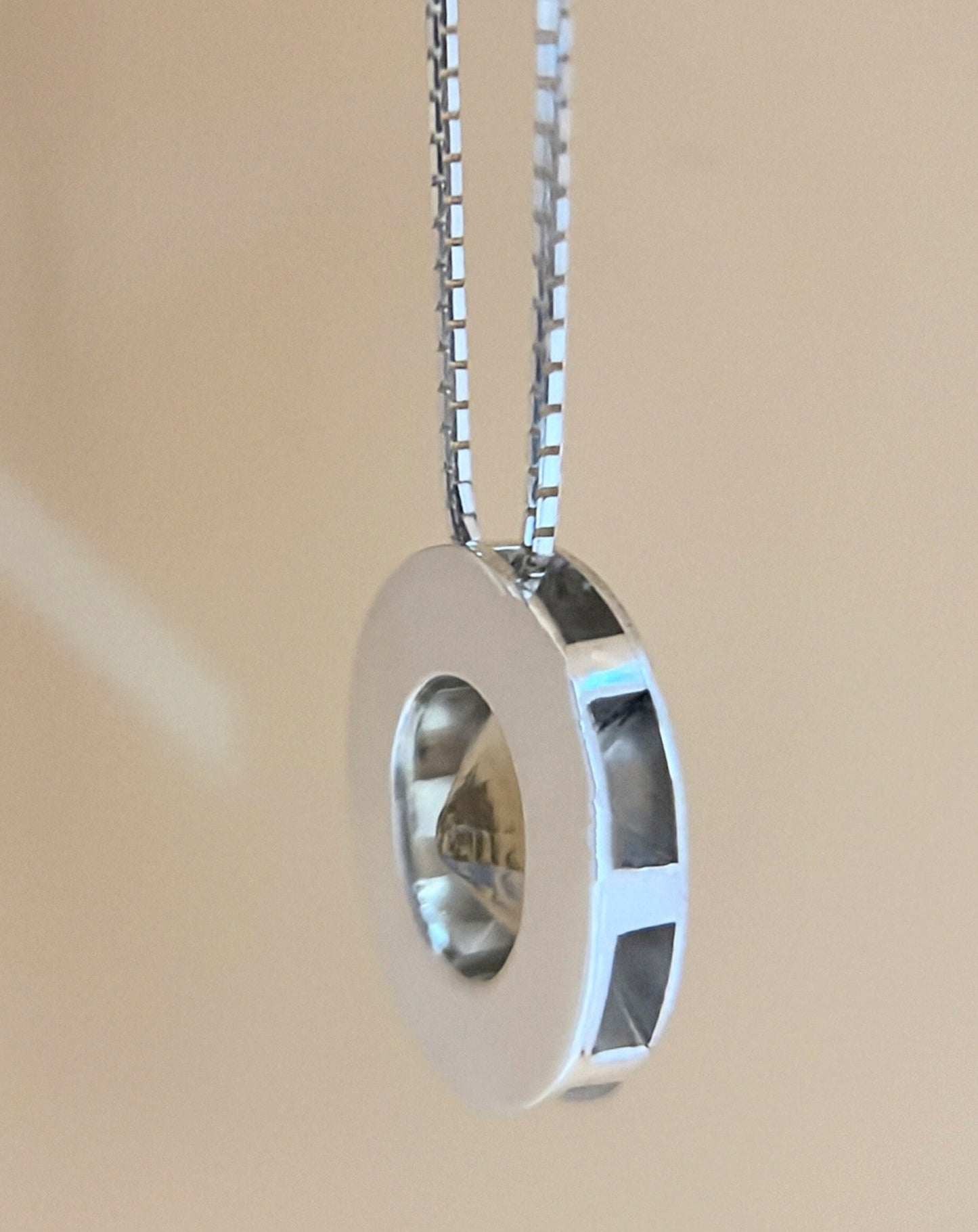 Side view of citrine pendant necklace in sterling silver showing the open bezel design that enhances light reflection through the gemstone.