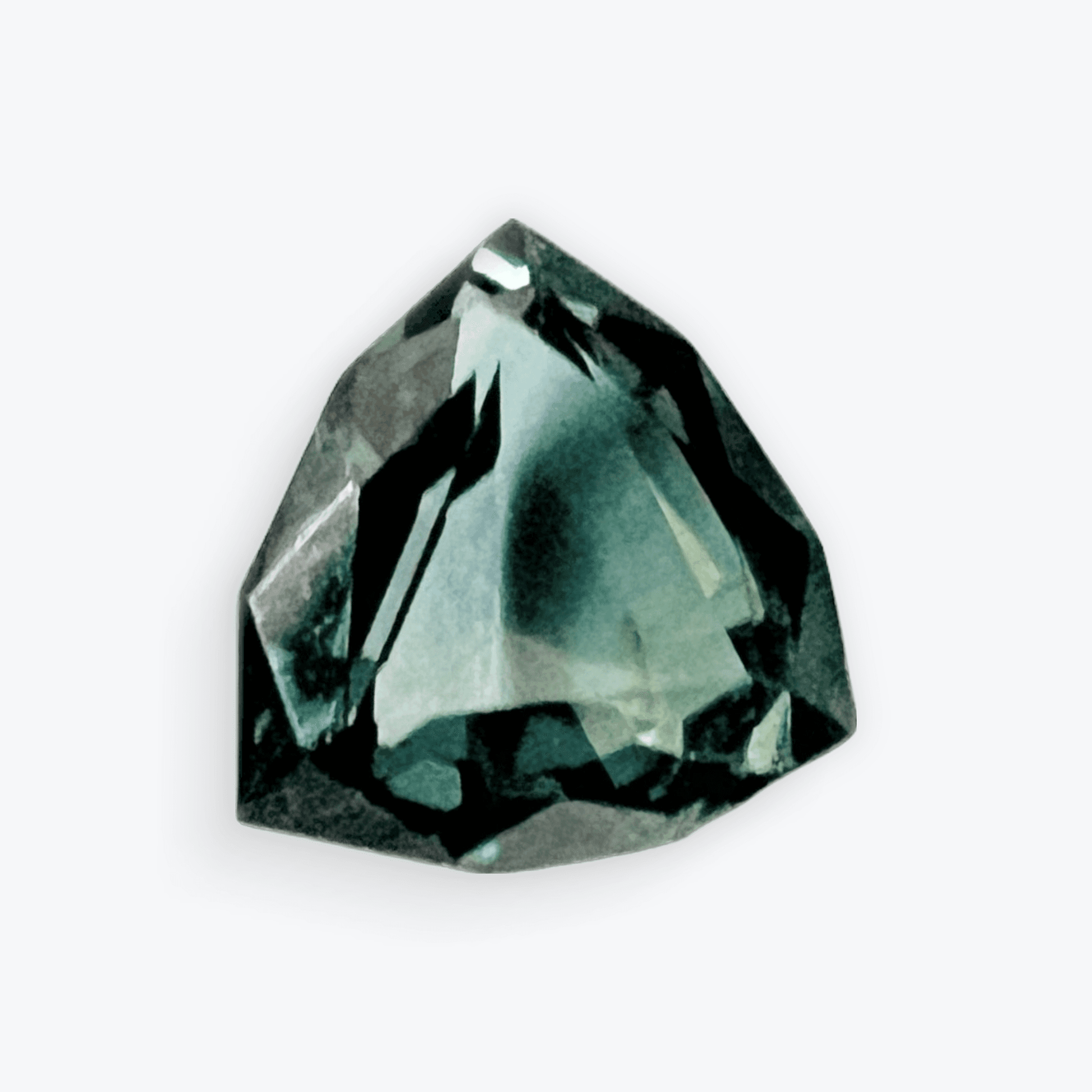 Loose trillion cut teal blue sapphire gemstone with a deep greenish-blue hue, perfect for custom jewelry designs.