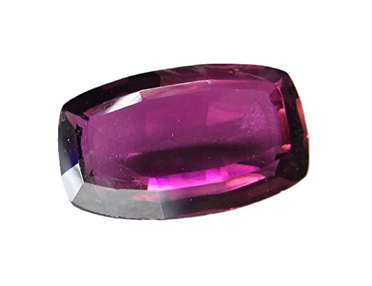 2.6ct oval pinkish red rubellite tourmaline gemstone with a faceted cut, showcasing deep pink hues and brilliance, ideal for custom jewelry designs.