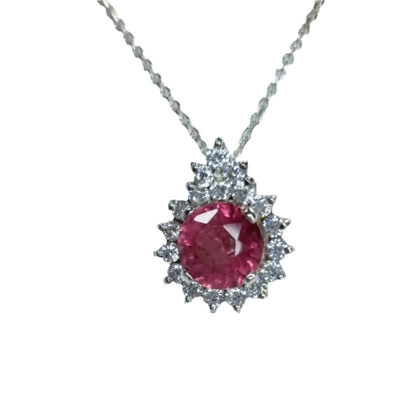 a necklace with a large pink stone in the center