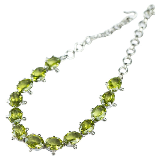 13ctw Mint Green Peridot Tennis Bracelet with oval-cut gemstones set in sterling silver. Adjustable chain for a perfect fit, ideal for elegant wear.