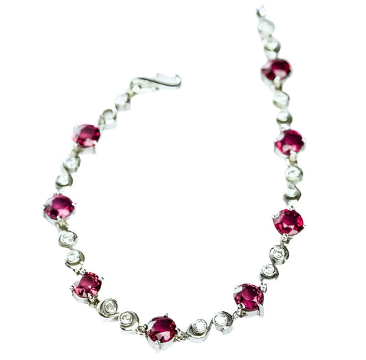 8.25ctw Pink Tourmaline Tennis Bracelet featuring round-cut pink tourmaline and white zircon stones set in a sleek silver-tone metal.