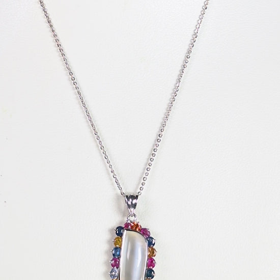 a necklace with a white stone surrounded by multicolored stones